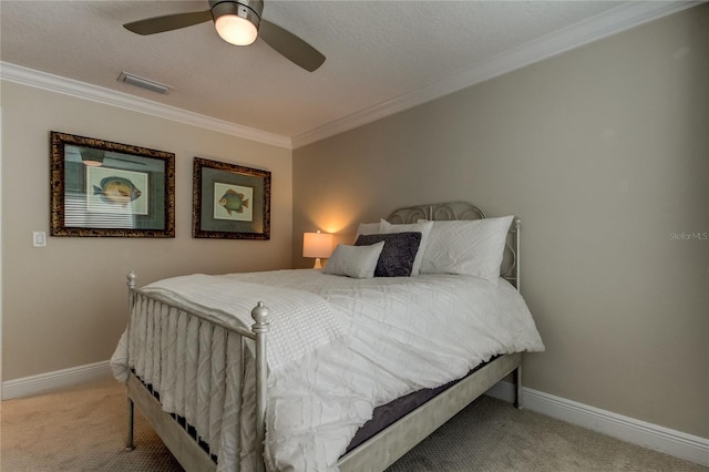 carpeted bedroom featuring a textured ceiling, ceiling fan, and crown molding