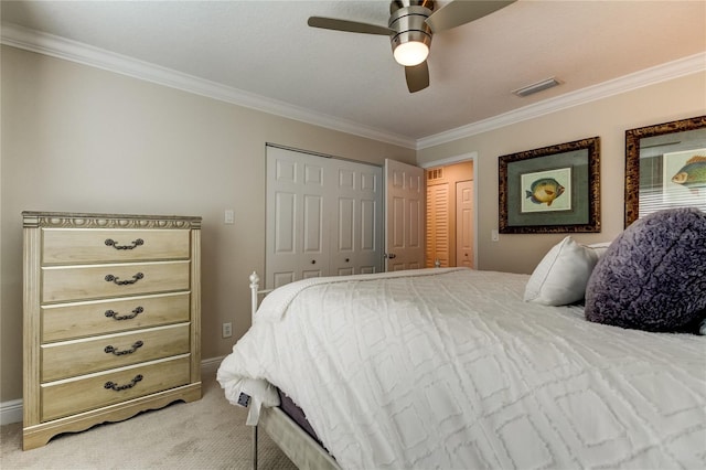 carpeted bedroom featuring a closet, ceiling fan, and crown molding