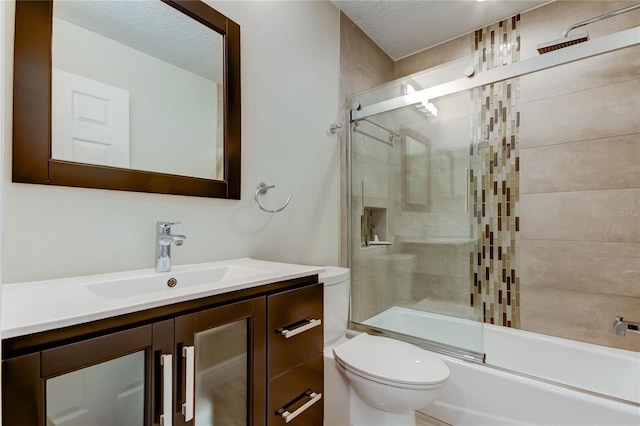 full bathroom with vanity, toilet, enclosed tub / shower combo, and a textured ceiling