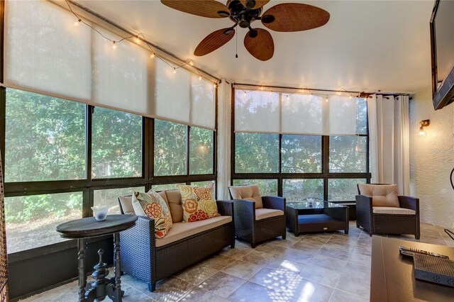 sunroom / solarium featuring ceiling fan