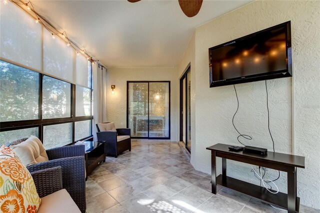 sunroom with ceiling fan and track lighting