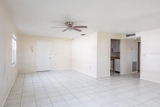 empty room featuring ceiling fan and light tile patterned flooring