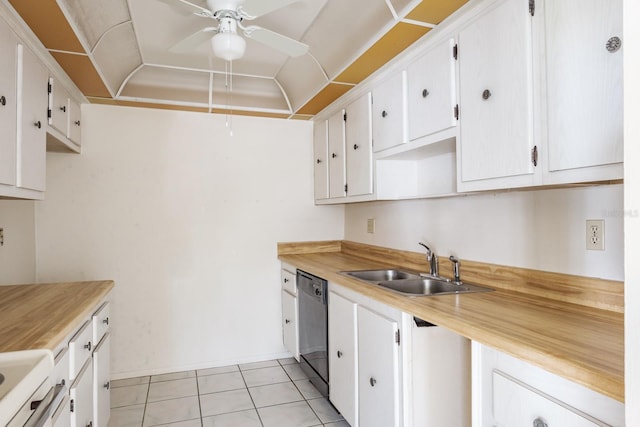 kitchen featuring white cabinetry, sink, light tile patterned flooring, and stainless steel dishwasher