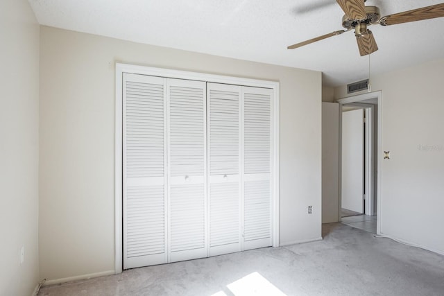 unfurnished bedroom with light carpet, a closet, and ceiling fan