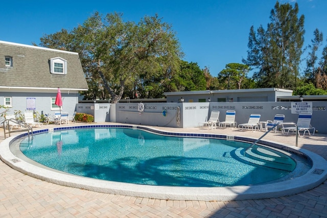 view of swimming pool featuring a patio area