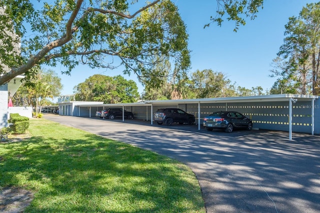 view of parking / parking lot with a yard