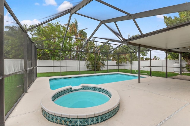 view of swimming pool with a lanai, a patio area, and an in ground hot tub