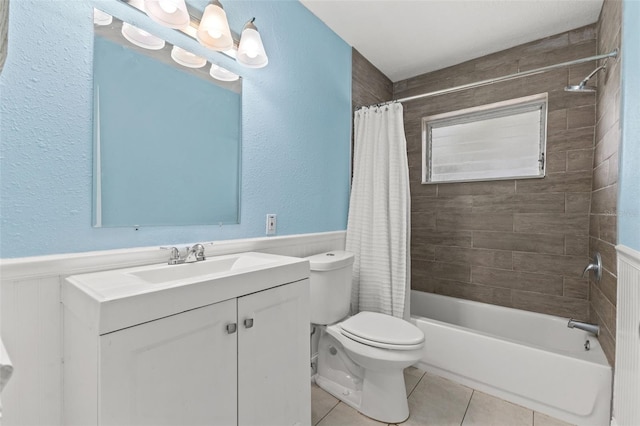 full bathroom with tile patterned flooring, vanity, shower / tub combo, and toilet