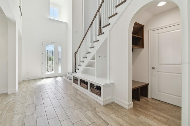 entryway featuring a towering ceiling