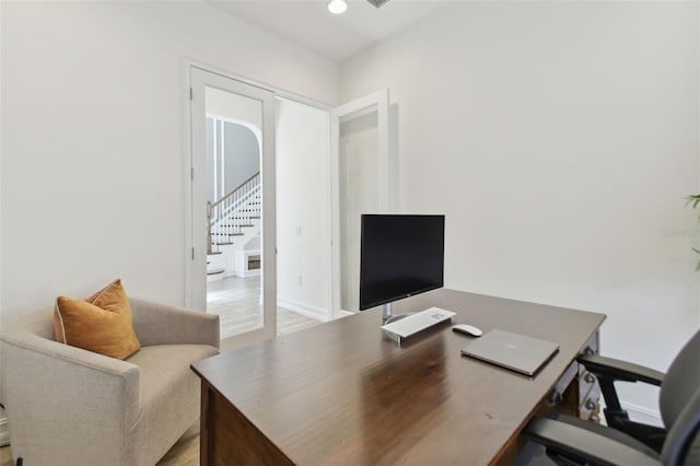 office area with light wood-type flooring and french doors