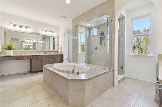 bathroom featuring vanity, tile patterned floors, and shower with separate bathtub