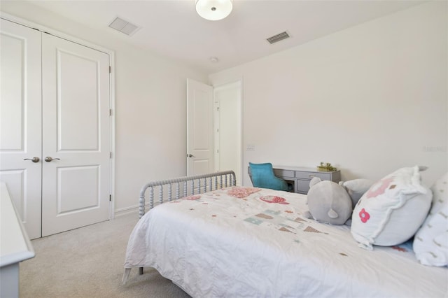 bedroom featuring light carpet and a closet