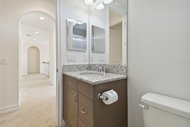 bathroom featuring toilet and vanity