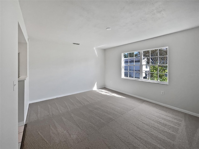 empty room featuring dark colored carpet