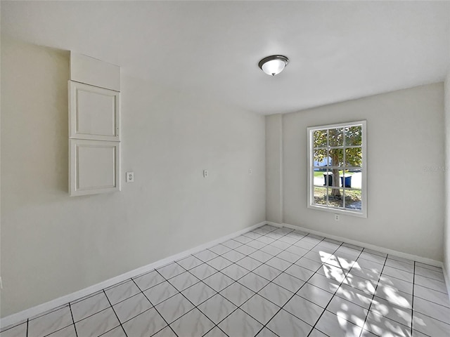 unfurnished room featuring light tile patterned floors