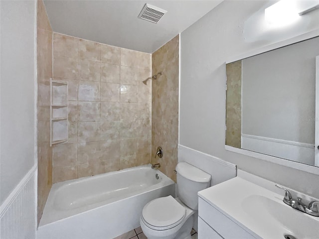 full bathroom featuring vanity, tiled shower / bath combo, toilet, and tile patterned flooring