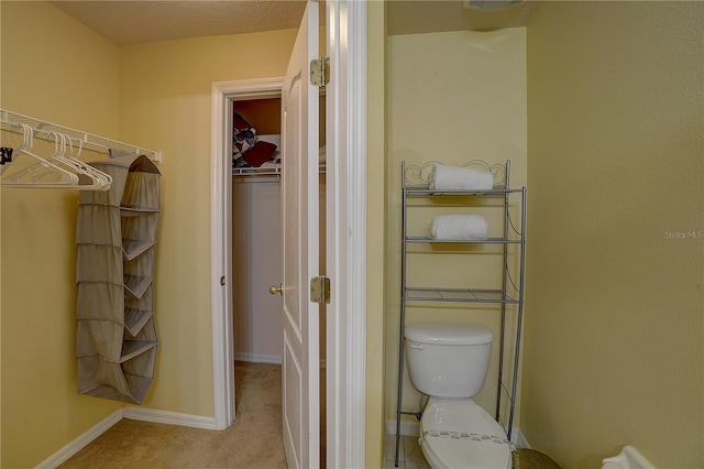 bathroom with a textured ceiling and toilet