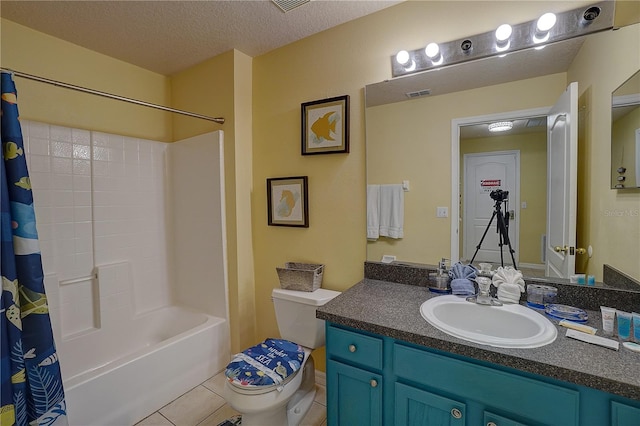 full bathroom with vanity, a textured ceiling, shower / bathtub combination with curtain, tile patterned flooring, and toilet