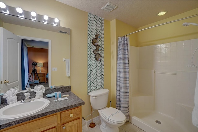 bathroom with walk in shower, tile patterned floors, a textured ceiling, toilet, and vanity