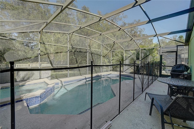 view of swimming pool featuring glass enclosure and a patio area