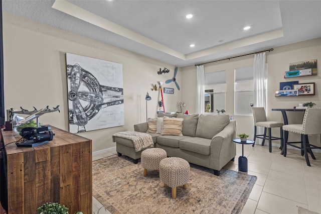 tiled living room with a raised ceiling