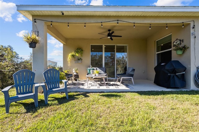 rear view of property featuring a lawn, a patio area, and ceiling fan