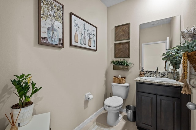 bathroom with tile patterned flooring, vanity, and toilet