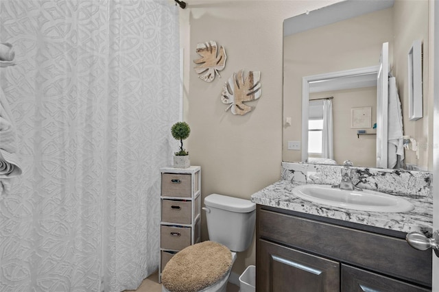 bathroom featuring vanity and toilet