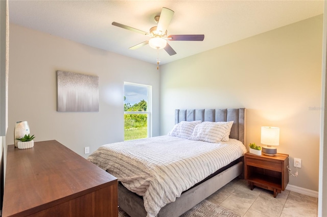 bedroom with ceiling fan and light tile patterned flooring