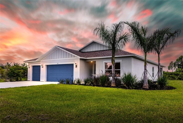 view of front facade with a garage and a lawn