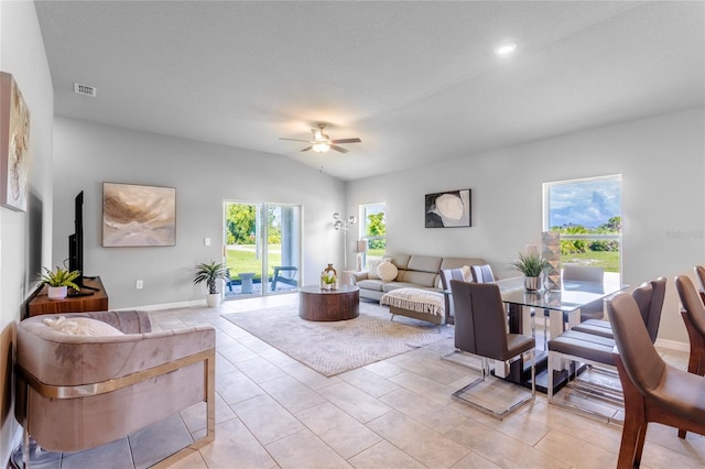 tiled living room with ceiling fan, a textured ceiling, and lofted ceiling