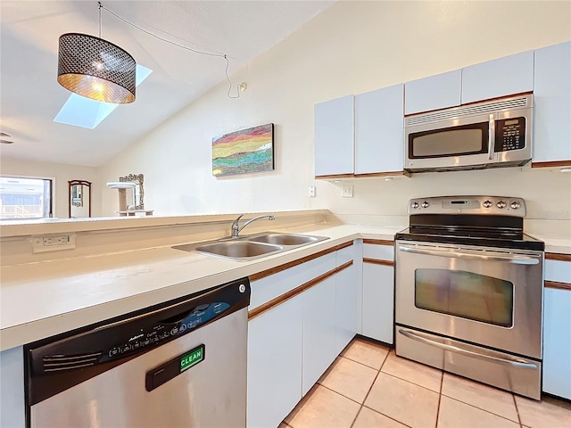 6262 93rd Ter N Unit 3904, Pinellas Park, FL 33782 - kitchen with appliances with stainless steel finishes, a skylight, lofted ceiling, light countertops, and light tile patterned floors