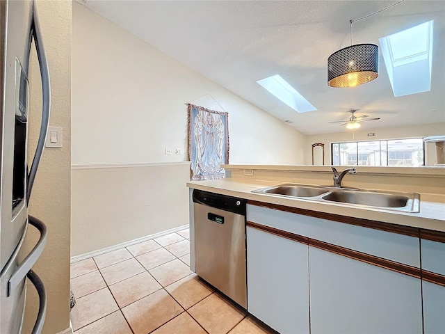 6262 93rd Ter N Unit 3904, Pinellas Park, FL 33782 - kitchen featuring a skylight, dishwasher, light tile patterned floors, vaulted ceiling, and fridge