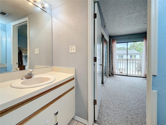 6262 93rd Ter N Unit 3904, Pinellas Park, FL 33782 - bathroom with vanity, a textured wall, and a textured ceiling