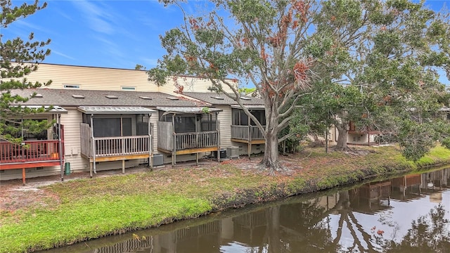 6262 93rd Ter N Unit 3904, Pinellas Park, FL 33782 - back of house with a sunroom, a shingled roof, and a deck with water view