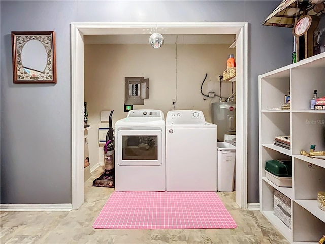 laundry area with water heater, washer and dryer, and electric panel