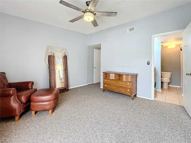 sitting room featuring a ceiling fan, carpet floors, and baseboards