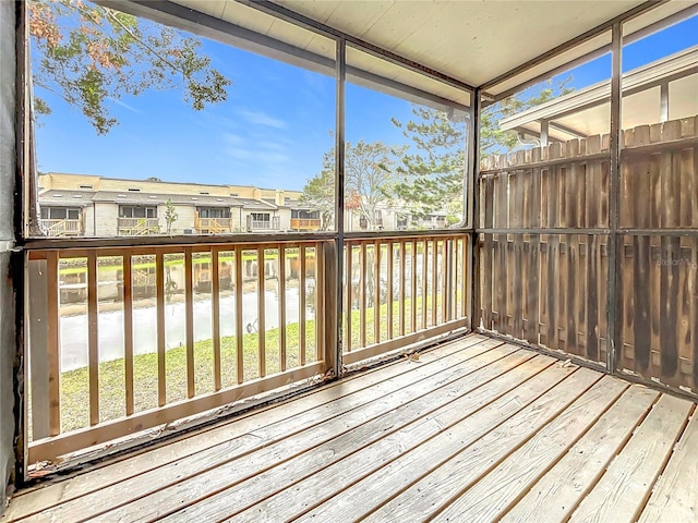unfurnished sunroom with a residential view and plenty of natural light