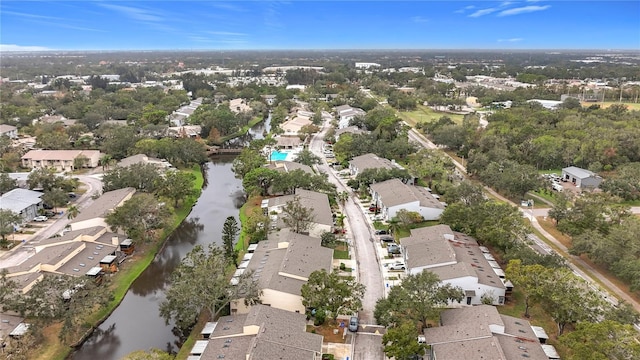 aerial view of property's location featuring nearby suburban area and a large body of water