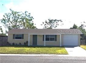 single story home featuring a front yard and a garage