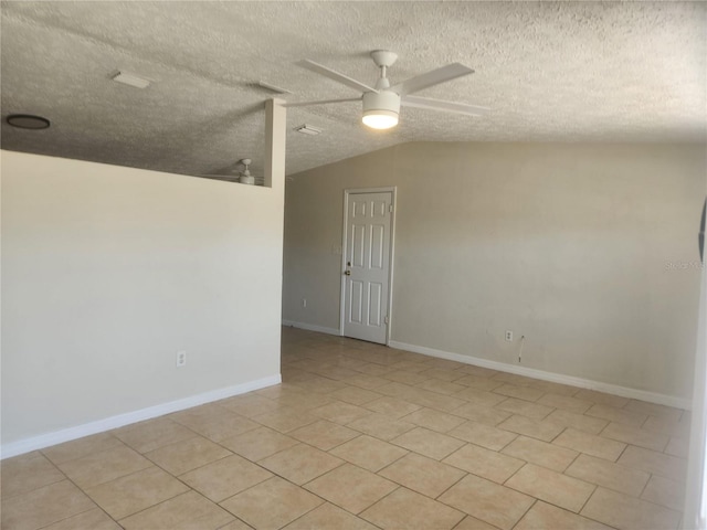 11608 Zimmerman Rd, Port Richey, FL 34668 - empty room with ceiling fan, lofted ceiling, light tile patterned flooring, a textured ceiling, and baseboards