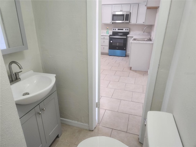 11608 Zimmerman Rd, Port Richey, FL 34668 - bathroom with vanity, toilet, and tile patterned flooring