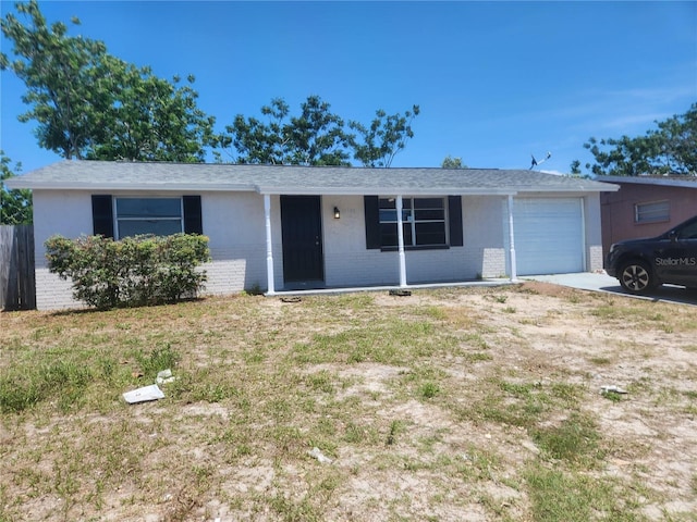 11608 Zimmerman Rd, Port Richey, FL 34668 - single story home featuring brick siding, a garage, and driveway