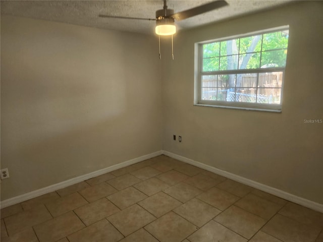 11608 Zimmerman Rd, Port Richey, FL 34668 - spare room featuring a ceiling fan, baseboards, a textured ceiling, and tile patterned flooring