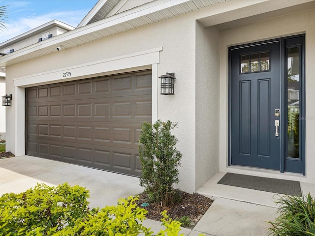 view of exterior entry featuring a garage