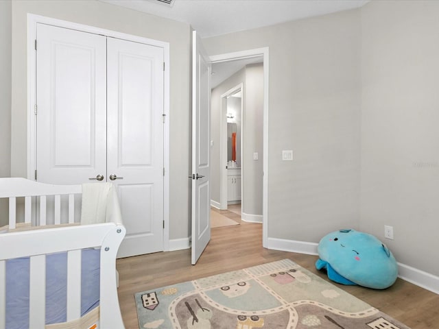 bedroom with a closet and hardwood / wood-style flooring