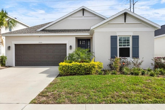 view of front facade featuring a front yard and a garage