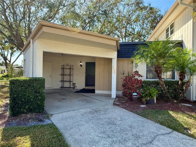 doorway to property featuring a carport