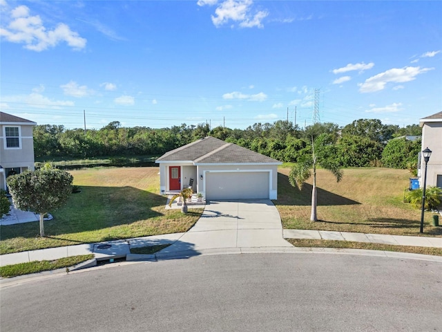 view of front of home with a garage and a front lawn