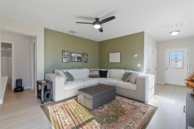 living room featuring ceiling fan and light hardwood / wood-style flooring